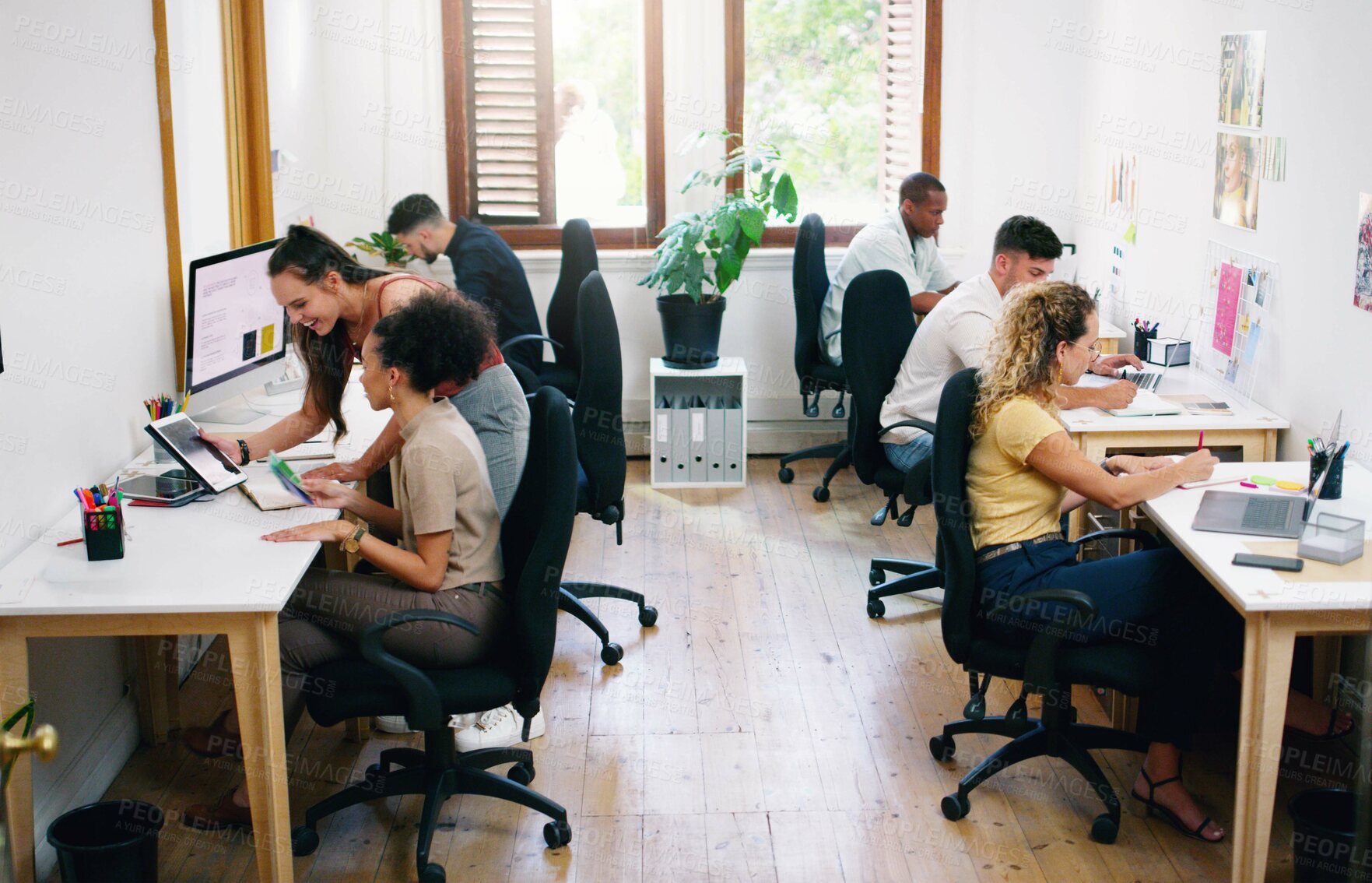 Buy stock photo Shot of a group of young businesspeople working together modern office