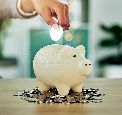 Investment, savings and growth hand with silver coin in a piggy bank investing in future wealth or financial development. Finance person invest or saving change, money or cash in overflowing jar