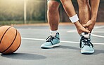 Basketball player, ankle pain and sports injury or accident on the court in a competitive game or training match outdoors. Athlete suffering with muscle inflammation, hurt leg joint or a broken bone 