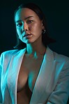 Sexy, portrait and fashion with a woman on a studio background for a luxury aesthetic. Creative, young and an Asian model or girl with a suit or vintage and isolated on a dark or black backdrop