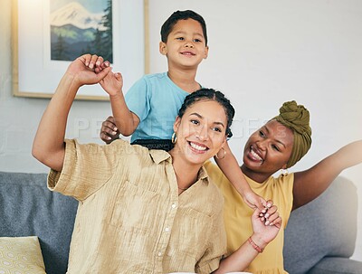 Buy stock photo Airplane, love and gay couple with boy child on a sofa for foster, bonding and playing in their home together. Lesbian, mothers and cheerful kid with parents in living room for piggyback fun games