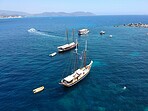 Aerial boat, sailing in Greece and summer sun on ocean holiday, relax in freedom and nature. Yacht vacation, travel and tropical cruise on sea adventure tour to Greek island on blue sky and water.