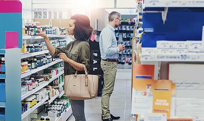 Buy stock photo People, shopping and shelf with pharmaceuticals for medication, self service or healthcare at pharmacy. Man, woman or customers checking medical supplies, stock or inventory at dispensary store