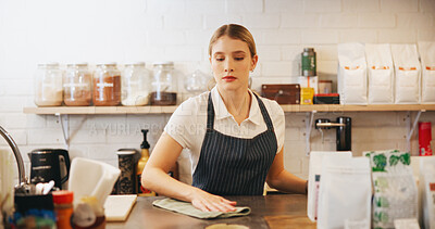 Buy stock photo Cafe, woman and business owner with cloth for cleaning, disinfection and wipe furniture. Entrepreneur, waiter or barista with coffee shop for hygiene, maintenance and workplace routine in restaurant