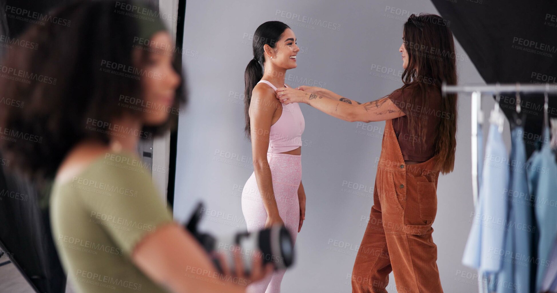 Buy stock photo Photography, stylist and model with women in studio for branding campaign, athleisure fashion line or promotion. Behind the scenes, ecommerce photoshoot or media launch with people on set for project