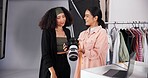People, camera and planning for photoshoot on set, collaboration and instructions for shooting. Women, photographer and speaking to stylist for fashion feedback, review image and backstage project