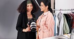 People, camera and planning for photoshoot in studio, collaboration and instructions for shooting. Women, photographer and speaking to stylist for fashion feedback, review image and backstage project