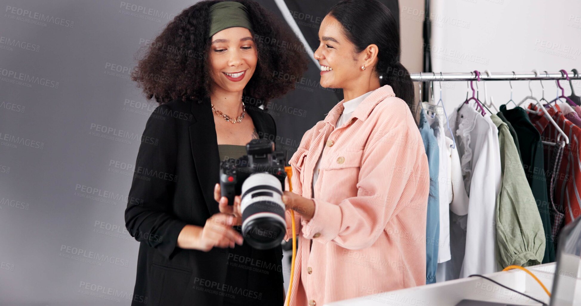Buy stock photo People, camera and planning for photoshoot in studio, collaboration and instructions for shooting. Women, photographer and speaking to stylist for fashion feedback, review image and backstage project