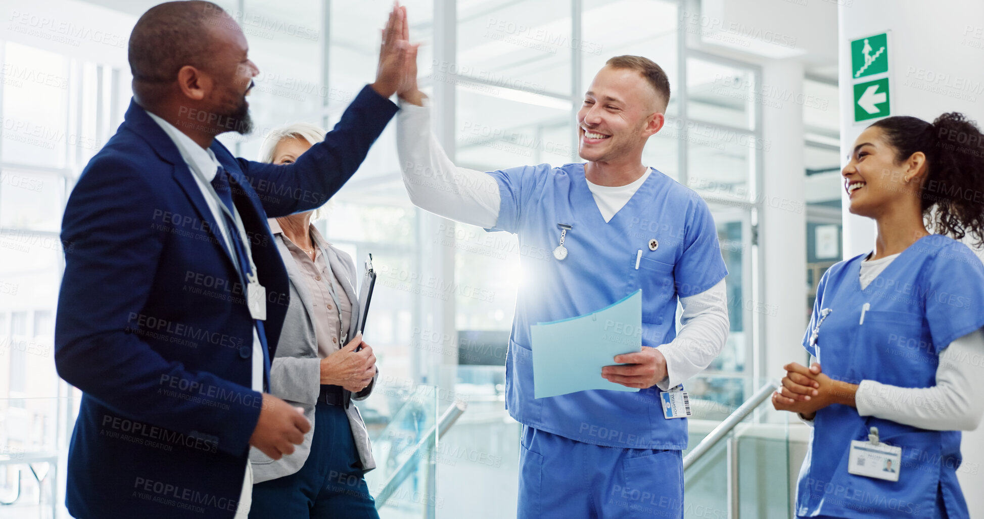 Buy stock photo Doctors, high five and celebration with team at hospital for breakthrough, diversity or happy for medical solution. Group, men and women with cheers, success or goal for healthcare services at clinic