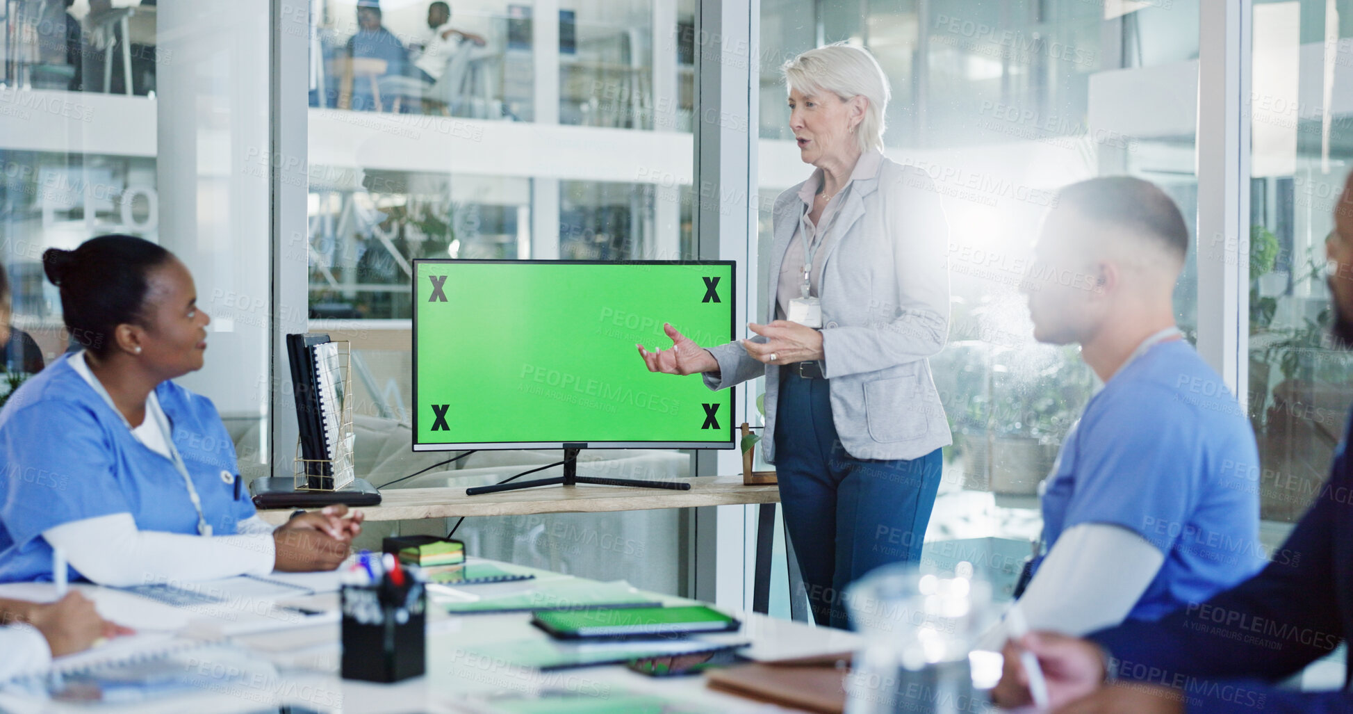 Buy stock photo Doctor, coach and team with green screen for presentation, medical training or conference at hospital. Mentor, leader or speaker with healthcare group, tracking markers or mockup space for meeting