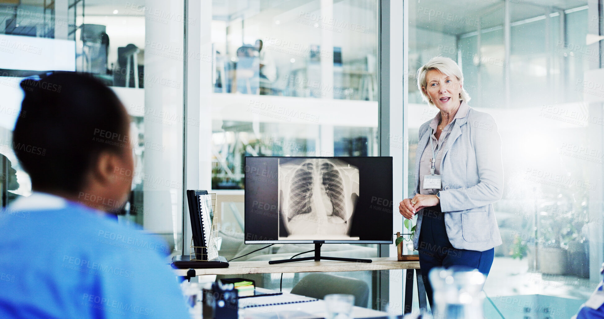 Buy stock photo Doctor, surgeon and coaching with screen for x ray, medical procedure or CT scan results at office. Mentor, leader or speaker with nurse or MRI for healthcare training or planning surgery at clinic