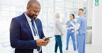 Buy stock photo Businessman, investor or medical funding with phone for online investment or healthcare campaign at hospital. Happy man, board director or shareholder with smile on mobile smartphone for health app