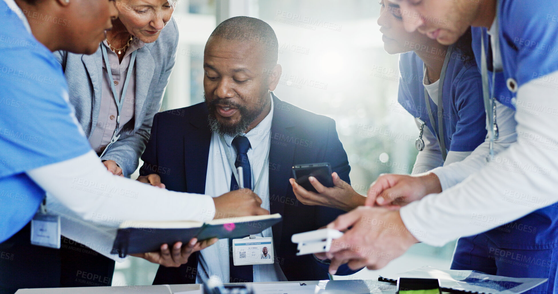 Buy stock photo Hospital director, man and multitasking in office with healthcare administration and staff management. People, doctor and nurses with appointment schedule, workflow and medical support in busy clinic