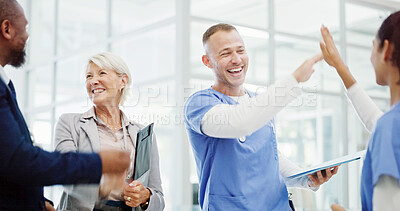 Buy stock photo Doctors, high five and celebration with group at hospital for breakthrough, progress and medical solution. People, men and women with cheers, success and goals for healthcare innovation at clinic