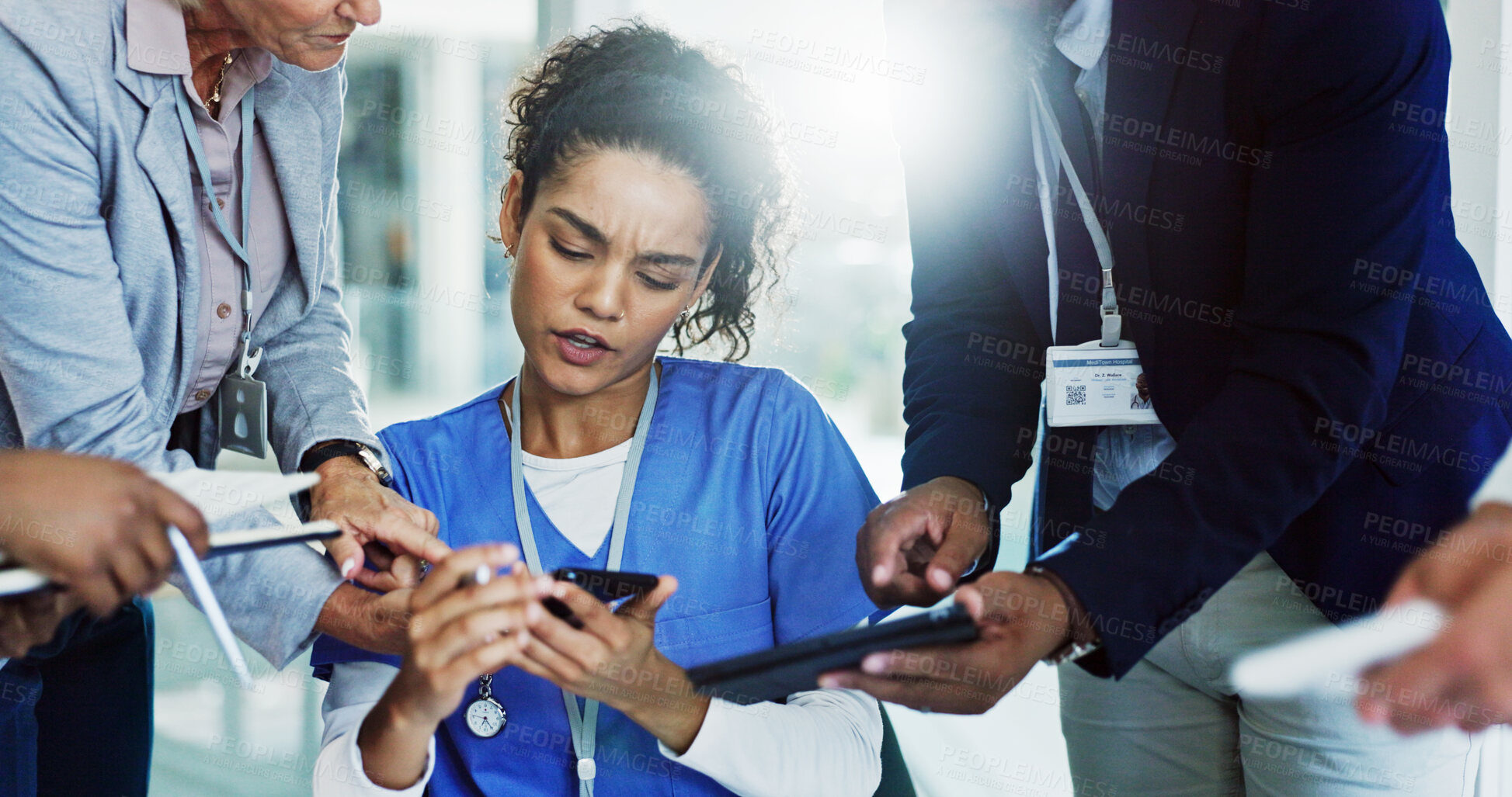 Buy stock photo Frustrated woman, nurse and multitasking with team for overworked pressure or chaos at busy hospital. Female person, healthcare employee or demanding colleagues with technology for workload stress