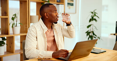 Buy stock photo Water, glass and black man at laptop in office for sustainable business, growth or development. Research, planning and consultant at desk drinking with online account management at eco design startup