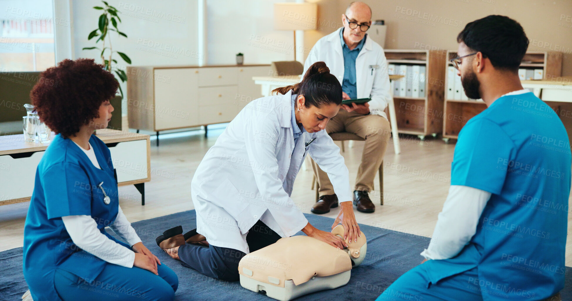 Buy stock photo Students, cpr or doctor teaching with mannequin for first aid practice, cardiac arrest or safety protocol. Healthcare class, people or nurses in medical simulation, paramedic course or nursing school