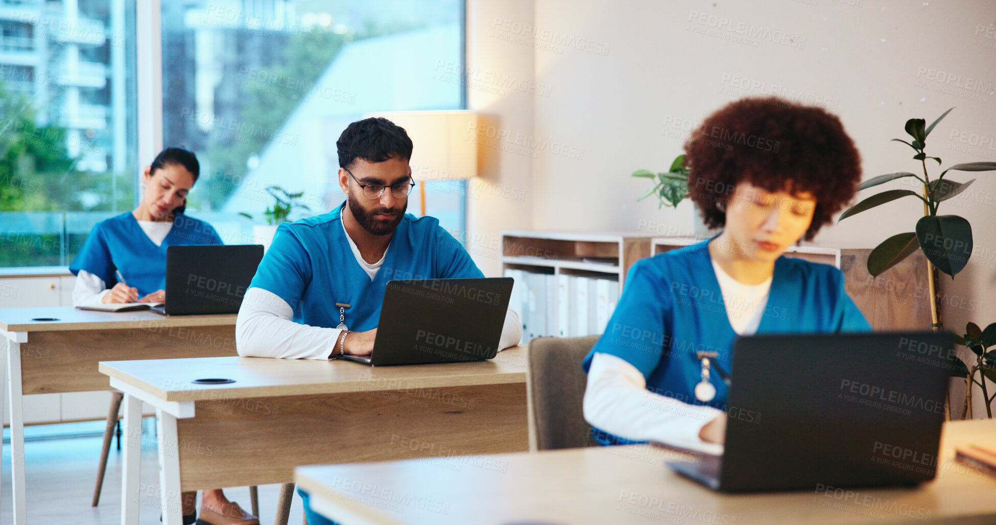 Buy stock photo Education, students and people with laptop, healthcare and serious for test in medical school and online. Typing, doctors and group in classroom for assessment, studying and research for medicine
