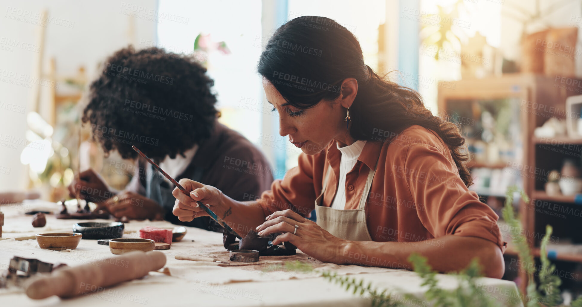 Buy stock photo Woman, brush and pottery in clay studio, workshop and art process for handmade ceramic design. Craft, hobby and artist with painting, artwork and talent in creative class for sculpture learning