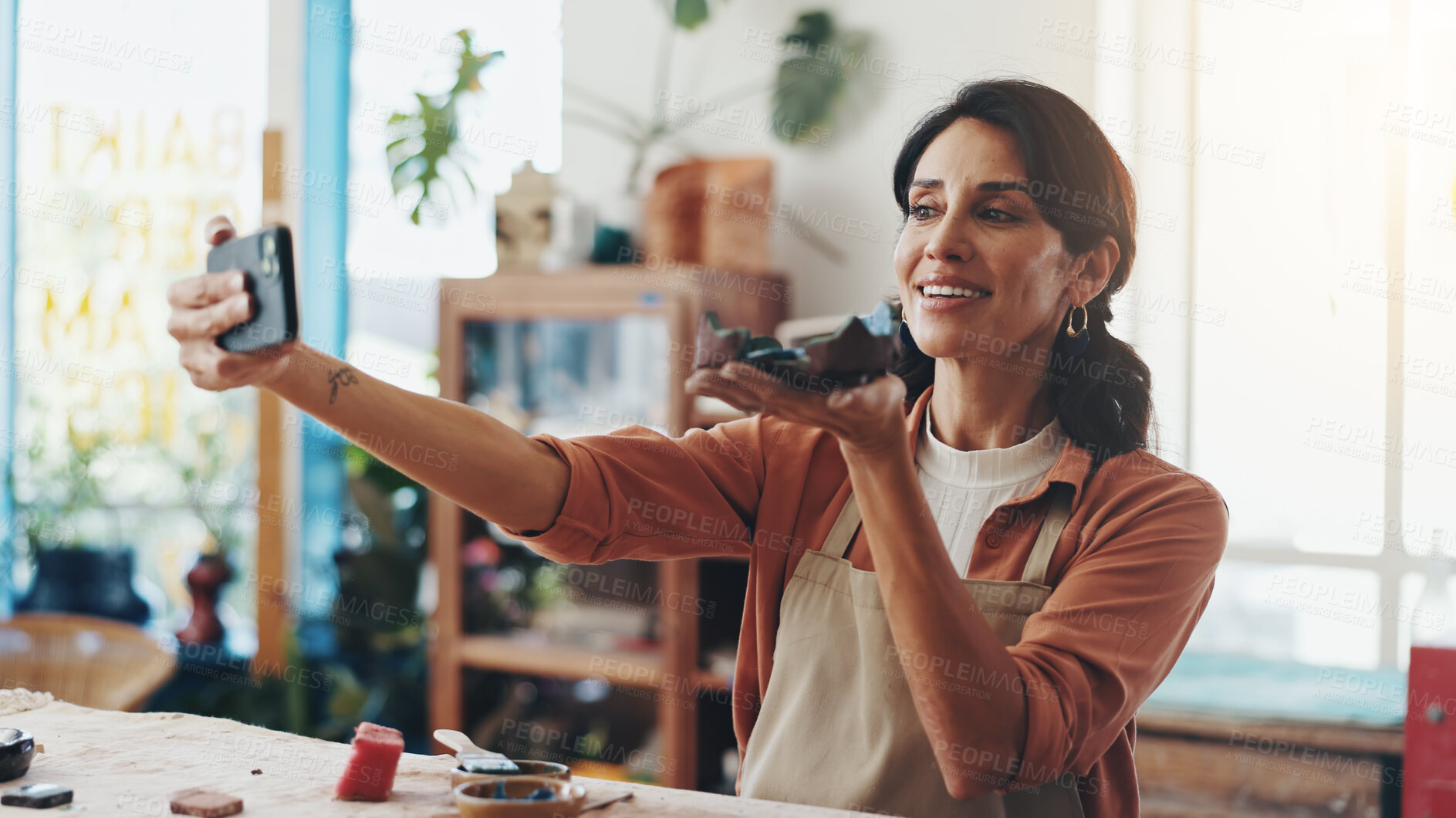 Buy stock photo Woman, selfie and ceramic in creative studio, workshop and art process for handmade pottery design. Craft, hobby and happy artist with fun, artwork and smile in clay class for sculpture learning
