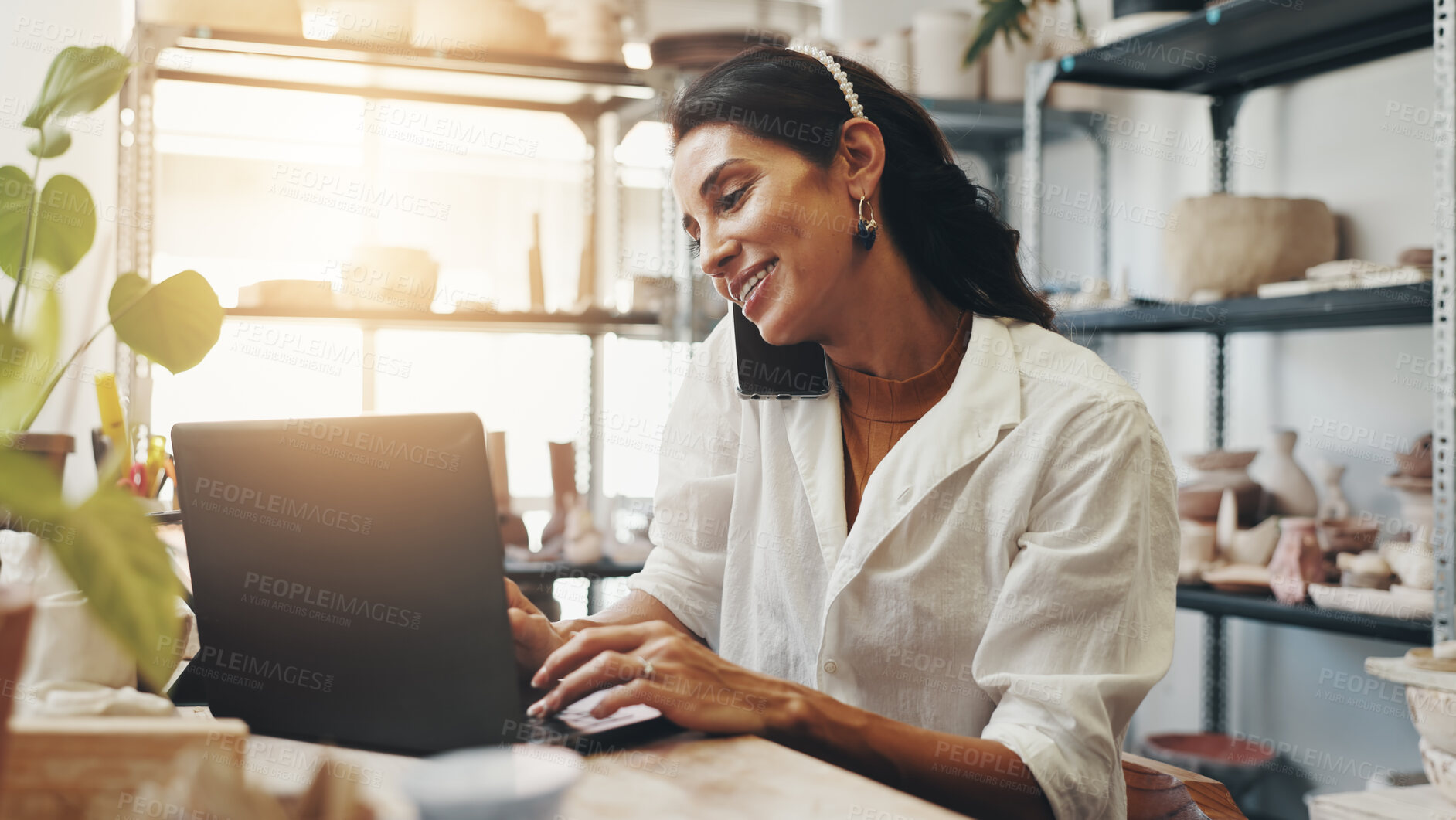 Buy stock photo Happy woman, laptop and pottery shop with phone call for online order or customer service at clay cafe. Female person, employee or talking with smile on mobile smartphone for small business startup