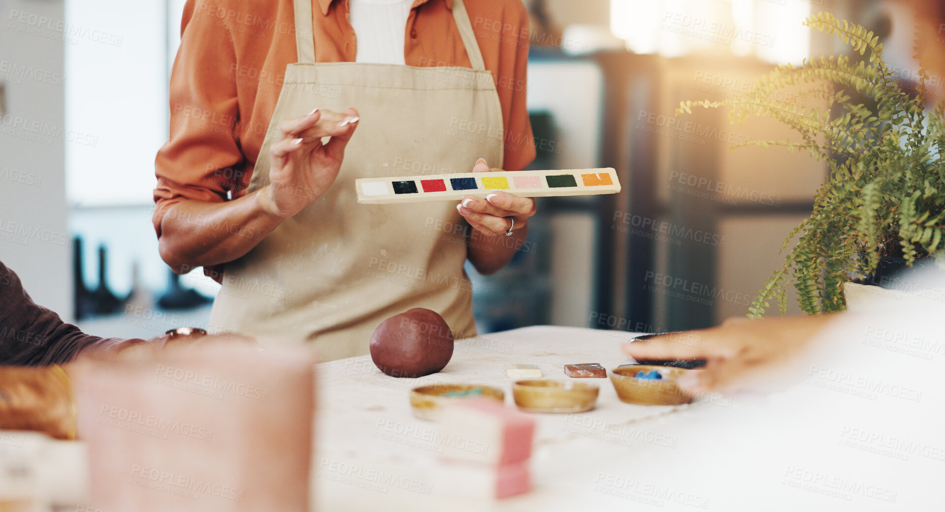 Buy stock photo Workshop, people and teacher with painting for pottery, development and creativity with learning in class. New skill, students and hands of mentor with sculpture, art design and teaching with palette