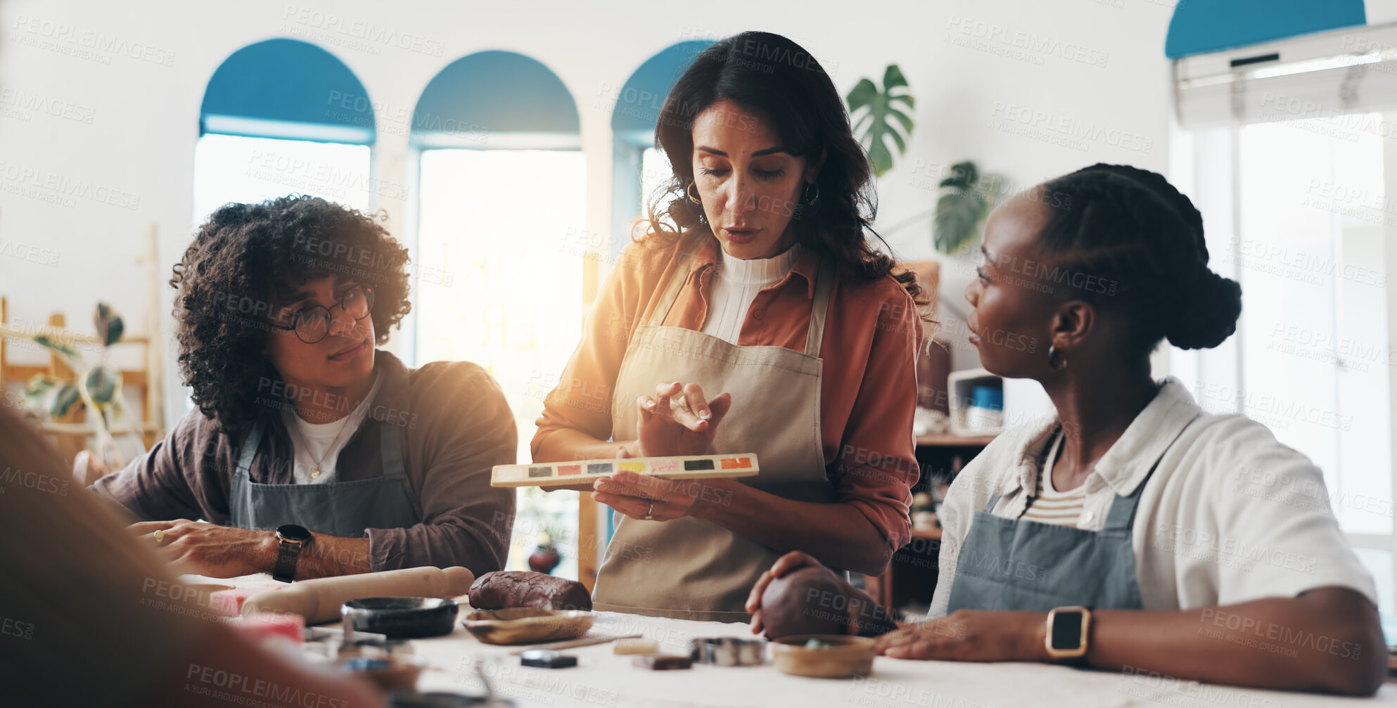 Buy stock photo Woman, pottery and class with group, teaching and color palette for paint, choice or process for results. People, coach and spectrum for creativity, sculpture or learning with diversity in art course