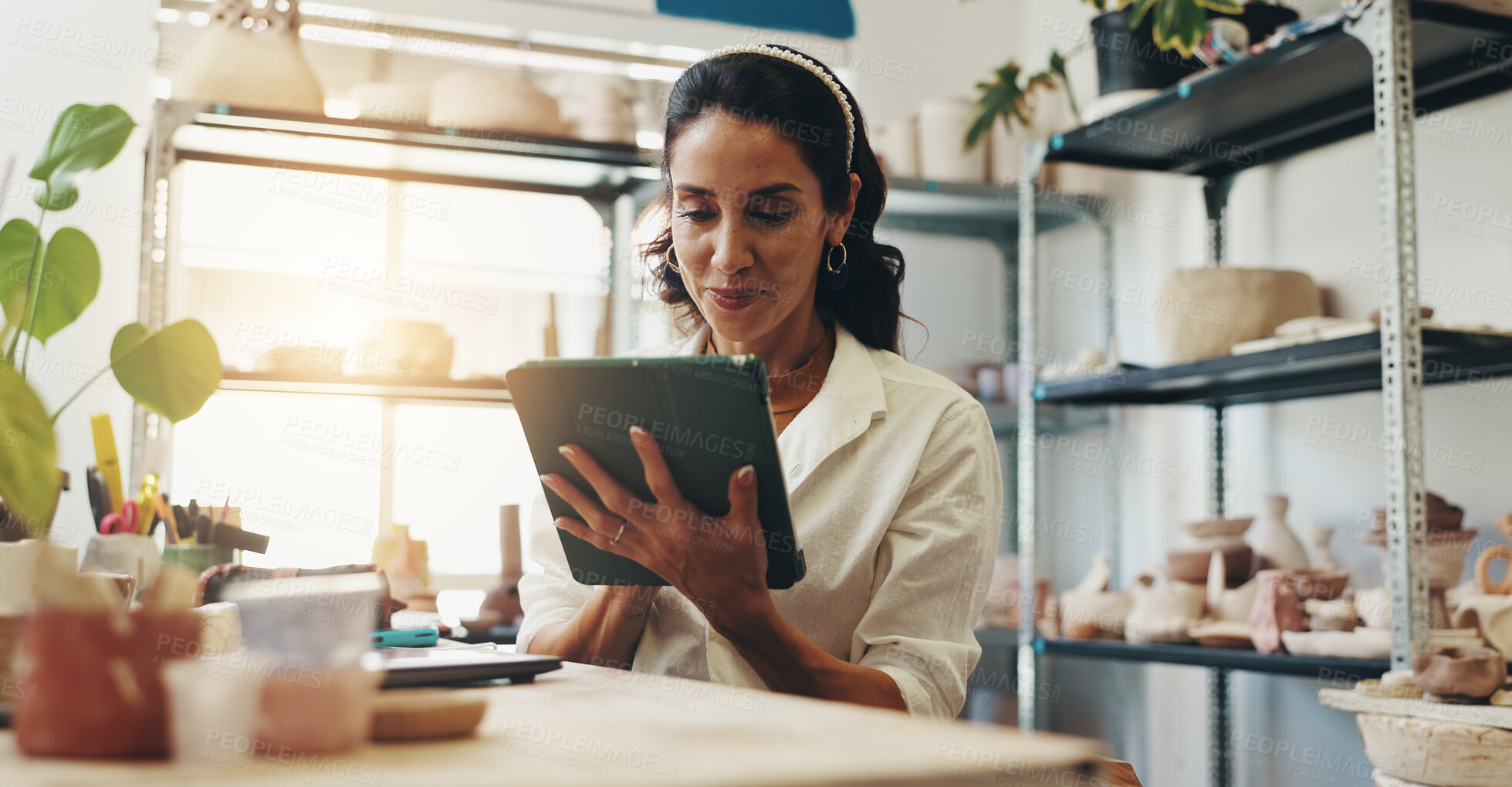 Buy stock photo Small business, smile and woman with tablet, pottery and happy for positive feedback, online and creative. Browsing, entrepreneur and reading of review for shop, artisan and proud for growth of store