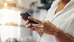 Person, hands and phone in small business for contact., social media update and ecommerce in boutique. Entrepreneur, store owner and typing on mobile for networking, online shopping and 
