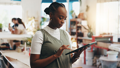 Buy stock photo Workshop, woman and research with tablet for pottery, design inspiration or verification for order. Small business, female ceramist and scroll with tech for clay information, track stock or inventory