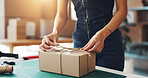 Shipping, box and string with hands of person for product return, dropshipping and cargo stock. Packaging, distribution and courier parcel with closeup of employee in factory for export delivery