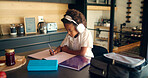 Child, writing and headphones for education in home, homework and student listening to audio. Boy, notebook lesson and elearning podcast for studying, language project and kid for mind development