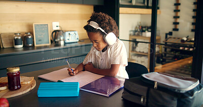 Buy stock photo Child, writing and headphones for education in home, homework and student listening to audio. Boy, notebook lesson and elearning podcast for studying, language project and kid for mind development