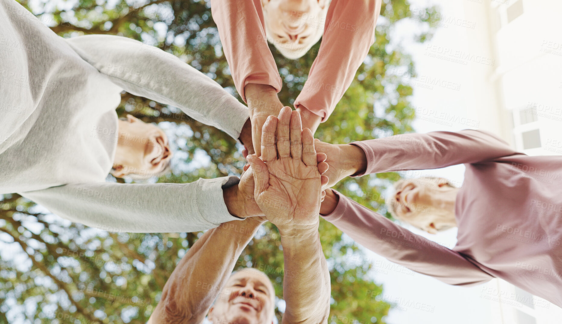 Buy stock photo Outdoor, senior people and hands with huddle for fitness, support and celebration together by below. Nature, retirement and friends with stack for solidarity, exercise goal or motivation by low angle