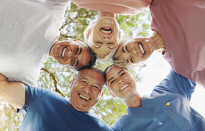 Buy stock photo Happy people, face or below with circle for unity, teamwork or social gathering in nature. Low angle, portrait or group with community in huddle, trust or support for mission, inclusion or solidarity