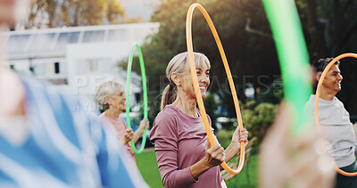 Buy stock photo Outdoor, senior people and exercise with hoop for physical fitness, wellness and rehabilitation. Retirement, coach and group of elderly women for training, workout and mental wellbeing with ring