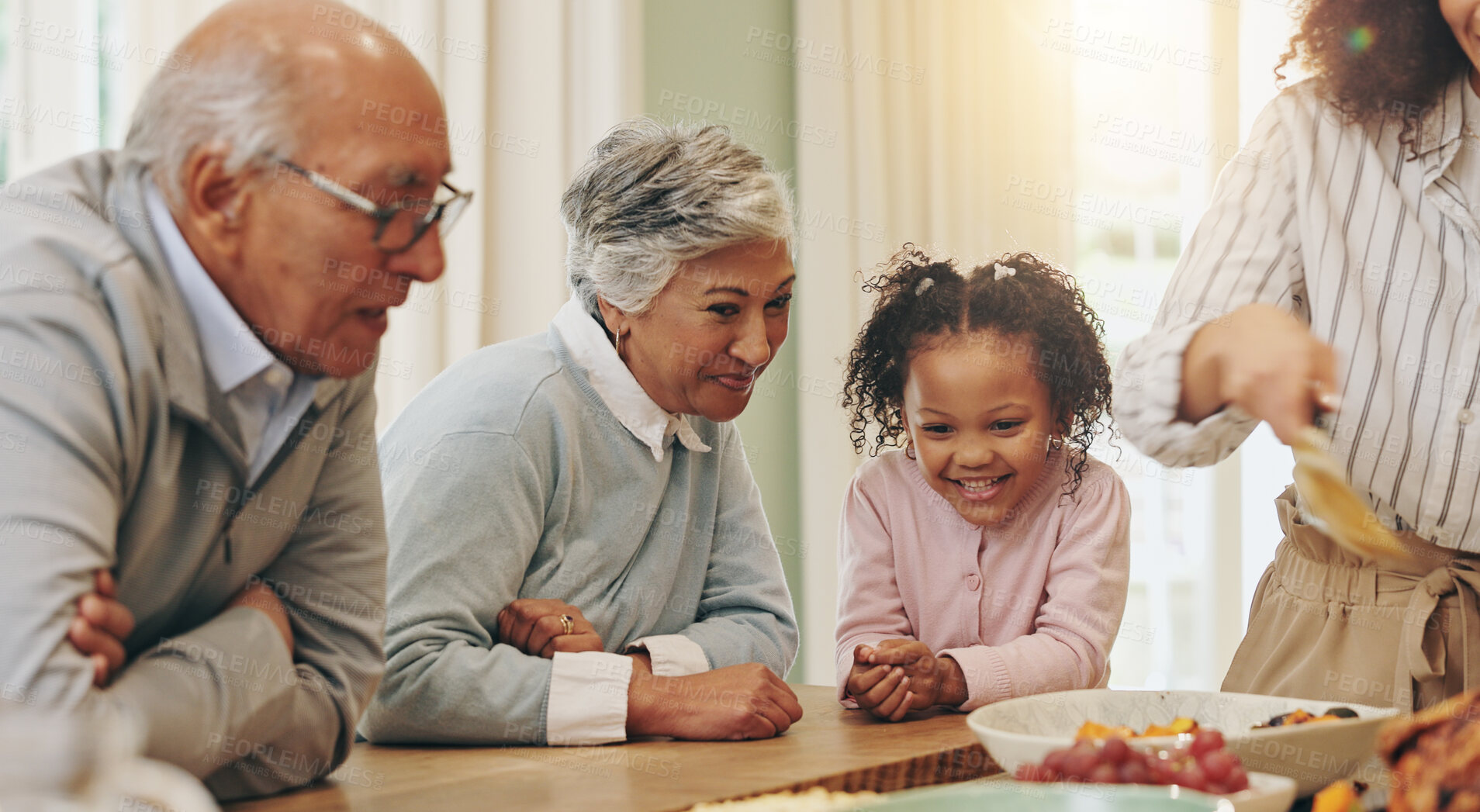 Buy stock photo Happy family, eating or dining with children for thanksgiving dinner together by table at home. Grandparents, child or dishing with smile, meal or lunch for bonding weekend or holiday feast at house