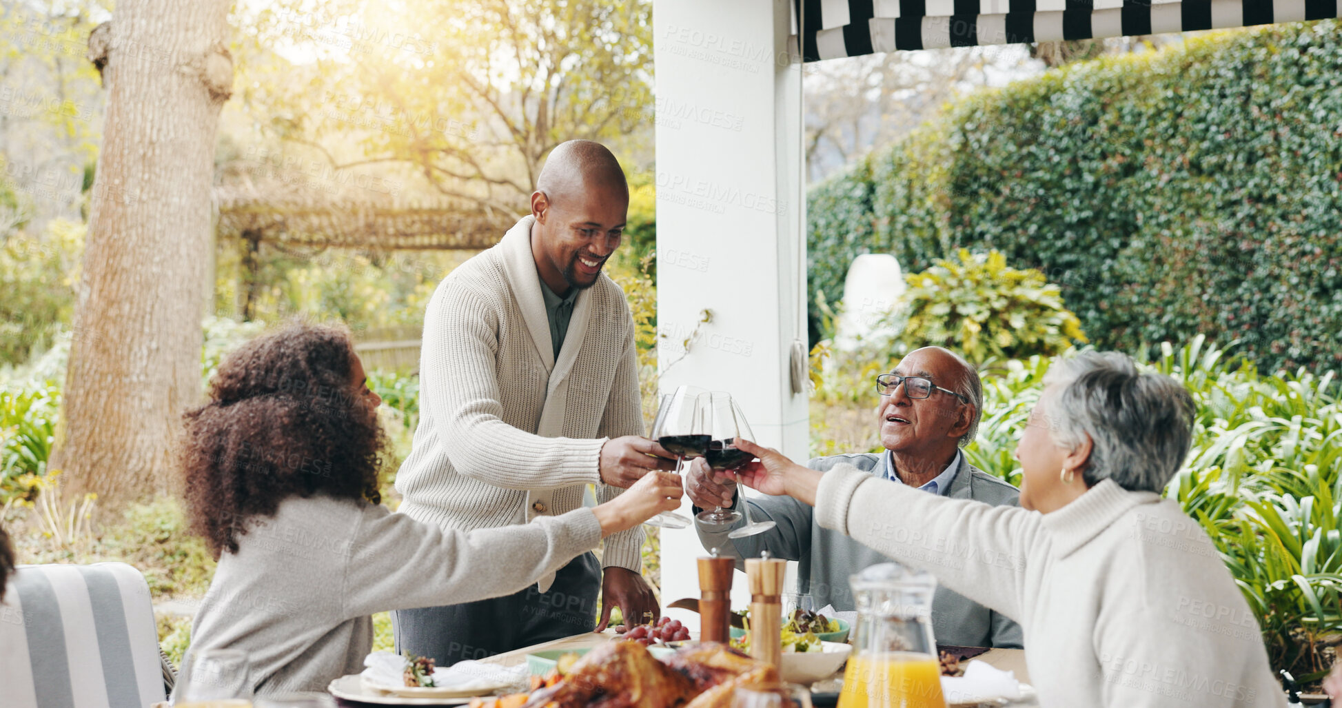 Buy stock photo Family, toast and outdoor dining table for celebration on vacation, easter lunch and proud to connect. Old people, cheers and share traditional holiday in garden, social gathering and patio party