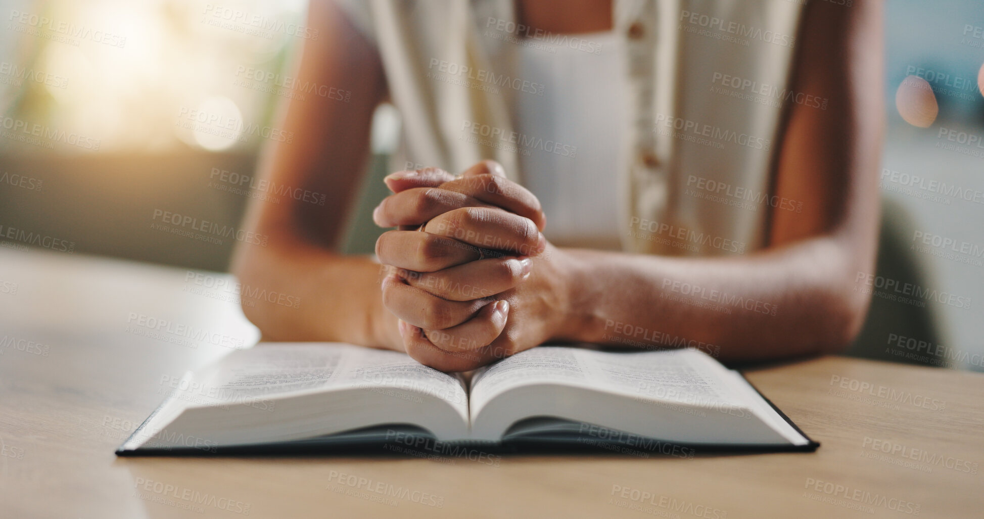 Buy stock photo Hands, praying and bible in home with religion, study and hope for change, spiritual or reflection in morning. Person, book and scripture with prayer, worship or learning for Christian faith in house