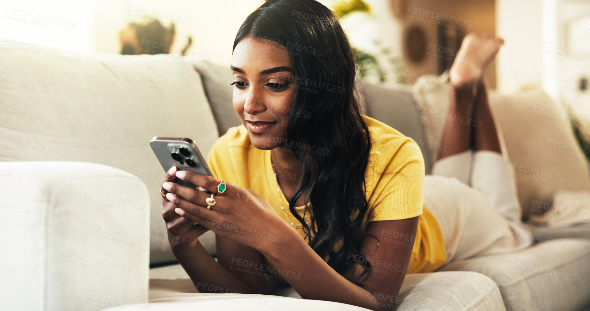 Buy stock photo Resting, reading and woman with smartphone, home and smile for romance ebook, online and comfortable. Lounge, relax and entertainment for person with mobile, website and browsing of novel in house