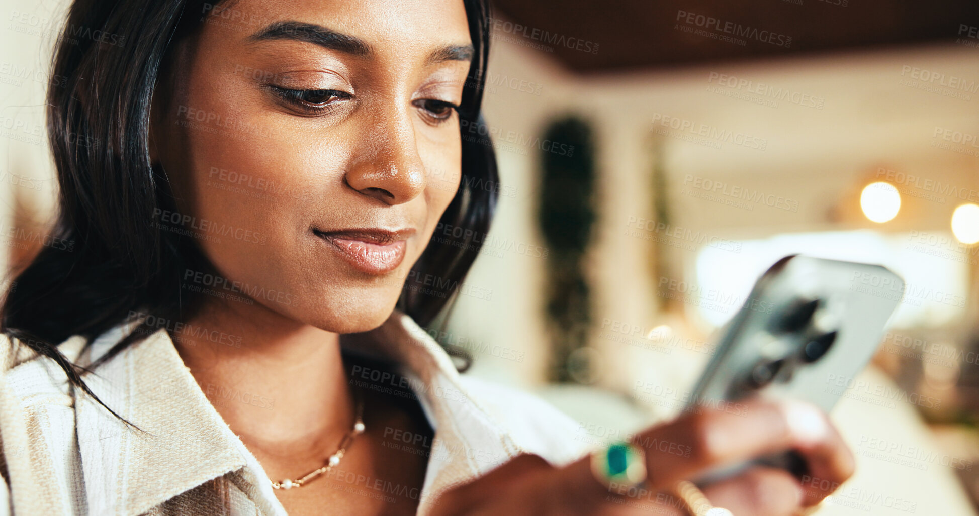 Buy stock photo Woman, phone and texting on sofa in home, chat and online dating with smile in living room. Girl, person and click with mobile app, contact and notification on social network in lounge at apartment