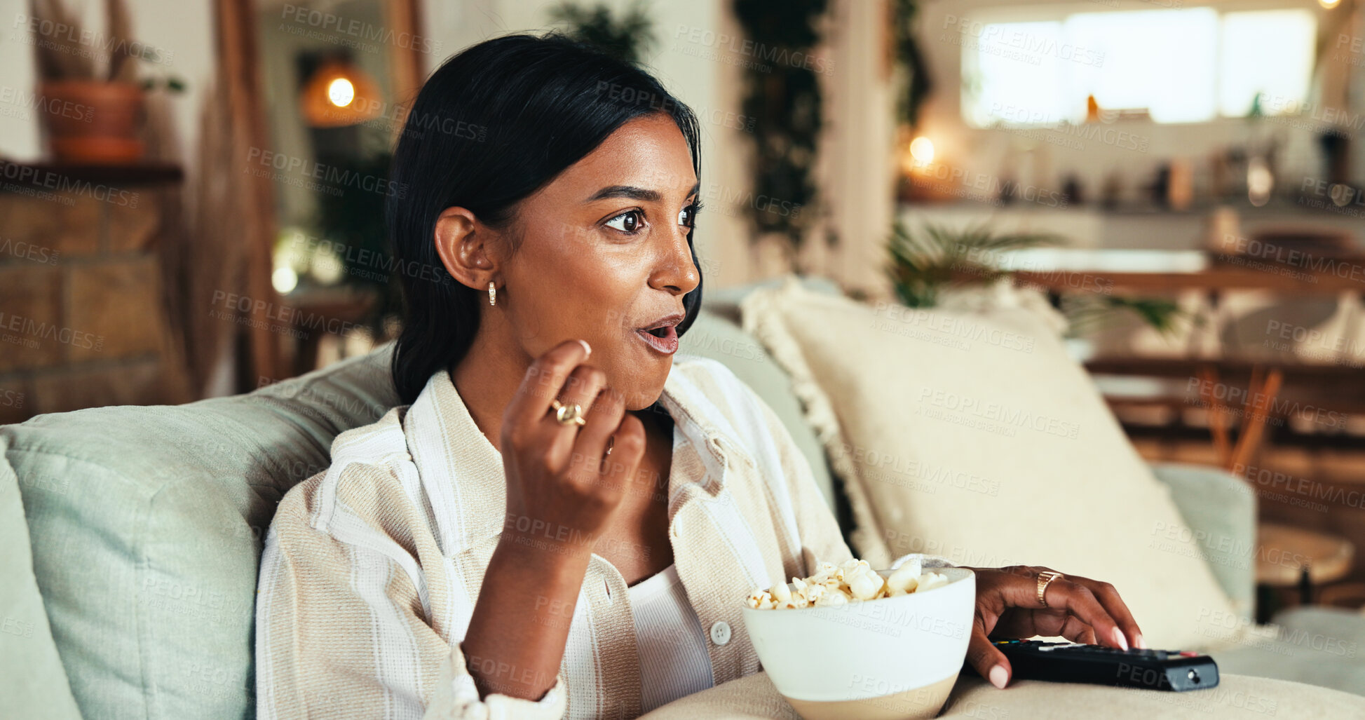 Buy stock photo Woman, watching tv and popcorn with surprise on sofa for film award show, relax and streaming in lounge. Girl, person and eating snack with wow, subscription and excited in living room at apartment