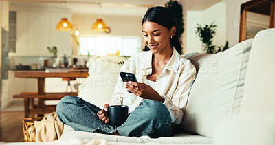 Buy stock photo Woman, phone and coffee on sofa with social media, reading blog and app subscription in home. Girl, warm beverage and mobile in living room for relax, streaming video and green tea benefits research