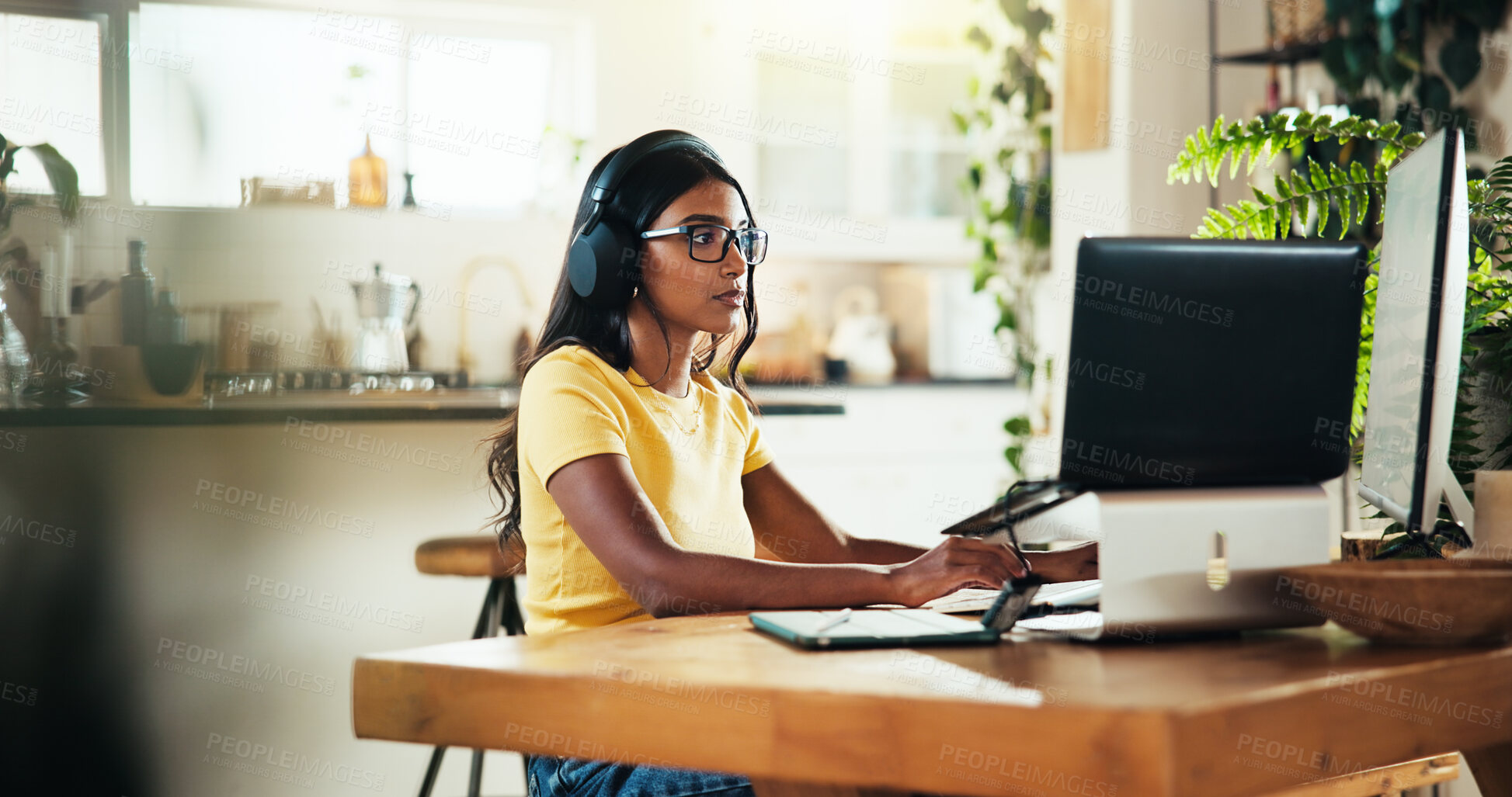 Buy stock photo Laptop, music and remote work with Indian woman in home office as graphic designer for marketing campaign. Computer, headphones and illustration with freelance employee in apartment for publication