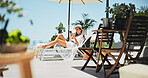 Woman, sunbathing and text with phone, vacation and relax for trip, break and travel. Luxury resort, social media post and girl with deck chair, adventure and smile for hotel accommodation review