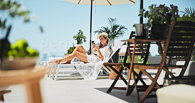 Buy stock photo Woman, sunbathing and text with phone, vacation and relax for trip, break and travel. Luxury resort, social media post and girl with deck chair, adventure and smile for hotel accommodation review