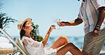 Couple, toast champagne and vacation on patio, relax or view by ocean, celebration or sunshine on valentines day. Mature people, man and woman for interracial love, drinks or holiday by sea in summer