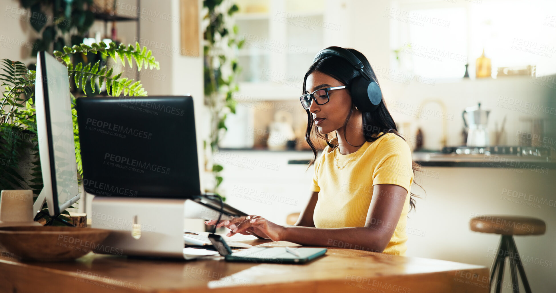 Buy stock photo Laptop, music and remote work with woman typing in home office as graphic designer for marketing campaign. Computer, freelance and headphones with Indian employee in apartment for publication