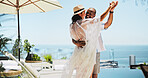 Couple, dancing and vacation on balcony by ocean, happy and excited for celebration in summer. Mature people, man and woman with interracial love, smile and holding hands by sea on valentines day