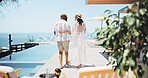 Back, swimming pool and couple with holiday, travel and bonding together with relationship. People, outdoor and man with woman, interracial or tropical island with romance, hospitality or anniversary